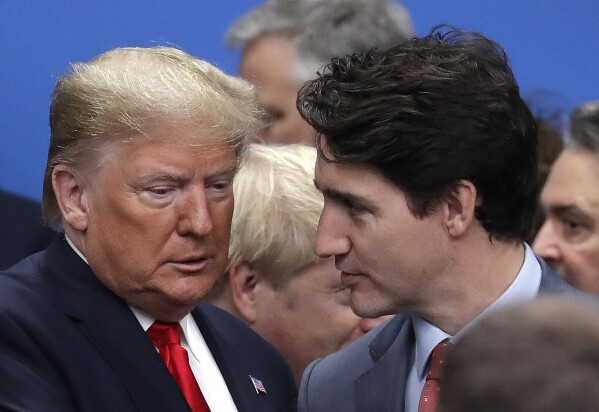FILE - President Donald Trump, left, and Canadian Prime Minister Justin Trudeau arrive for a round table meeting during a NATO leaders meeting at The Grove hotel and resort in Watford, Hertfordshire, England, Dec. 4, 2019. Canada's government is preparing for the possibility that Trump could reach the White House again and the “uncertainty” that would bring, Trudeau said Tuesday, Jan. 23, 2024, at a Cabinet retreat. (AP Photo/Evan Vucci, File)